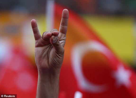 Soccer Football - Euro 2024 - Quarter Final - Netherlands v Turkey - Berlin Olympiastadion, Berlin, Germany - July 6, 2024 Turkey fan makes a 'wolf' salute inside the stadium before the match REUTERS/Thilo Schmuelgen