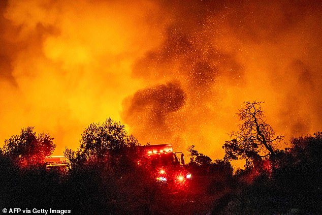 Pictures from the scene show red skies and trees on fire as firefighters run to control the situation