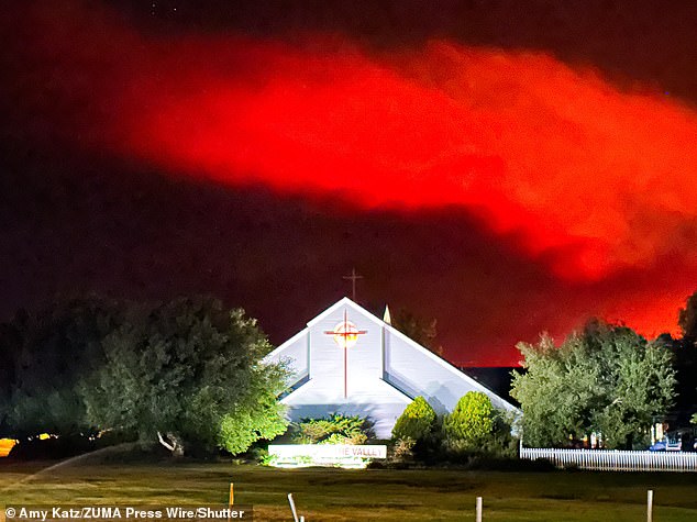 In Santa Ynez, a church stands tall against the ominous backdrop of the Lake Fire