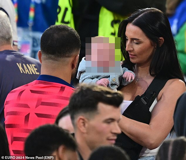 Following the game she handed over two-month-old son Rezon to the player