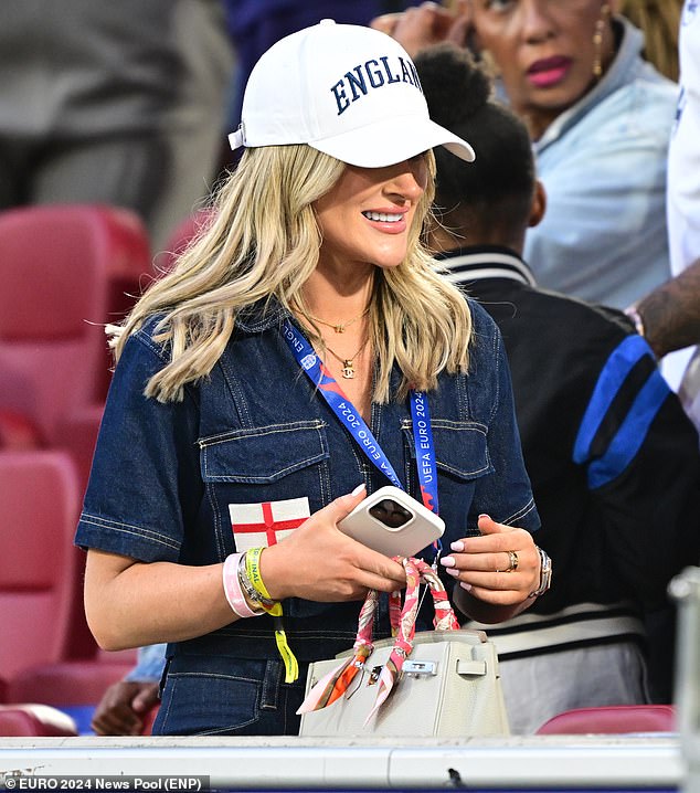 Elated Aine put on her England cap and picked up her 30K Hermes bag as she left her seat