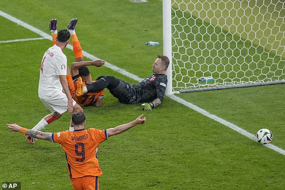 Cody Gakpo of the Netherlands, top second left, scores his sides second goal past Turkey's goalkeeper Mert Gunok during a quarterfinal match between the Netherlands and Turkey at the Euro 2024 soccer tournament in Berlin, Germany, Saturday, July 6, 2024. (AP Photo/Markus Schreiber)