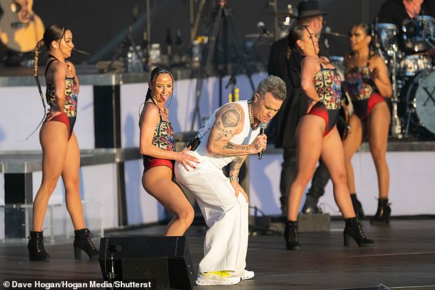 Robbie Williams' dancer grabbed a handful of his bottom as the star, 50, headlined BST Hyde Park on Saturday