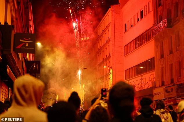 People watched fireworks released during a demonstration against the French far-right in Paris