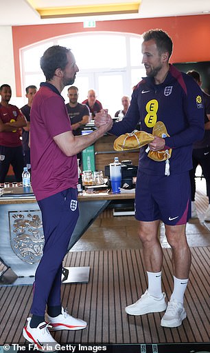 England captain Harry Kane presented Gareth Southgate with a gold cap in recognition of his 100 games in charge of the Three Lions