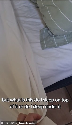 The woman was unsure how to sleep with the sheet