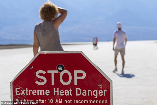 A person wipes sweat from their brow at Badwater Basin in Death Valley National Park where someone died on Saturday