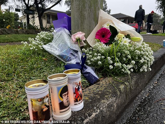 Shocked neighbours and friends placed flowers and candles outside the home on Monday