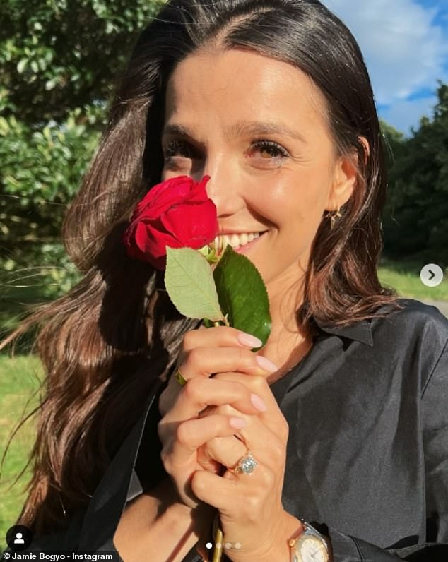 An adorable snap holding onto a rose  allowed Marisa to show off her whopping diamond ring