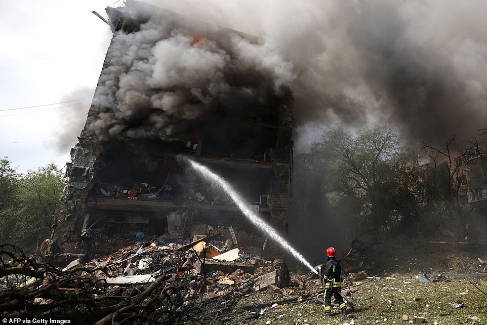 A Ukrainian firefighter works to extinguish a fire in a residential building following a missile attack in Kyiv on July 8, 2024