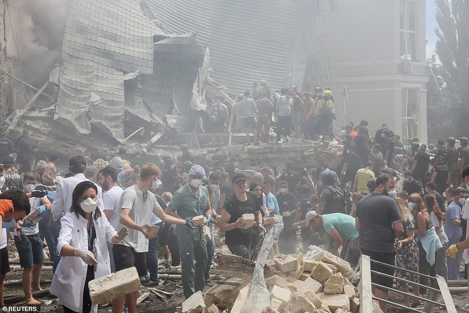 Rescuers work at Ohmatdyt Children's Hospital after it was struck by Russian missiles