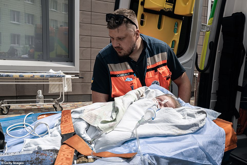 A child receives medical attention after the Russian missile strikes on a Kyiv children's hospital