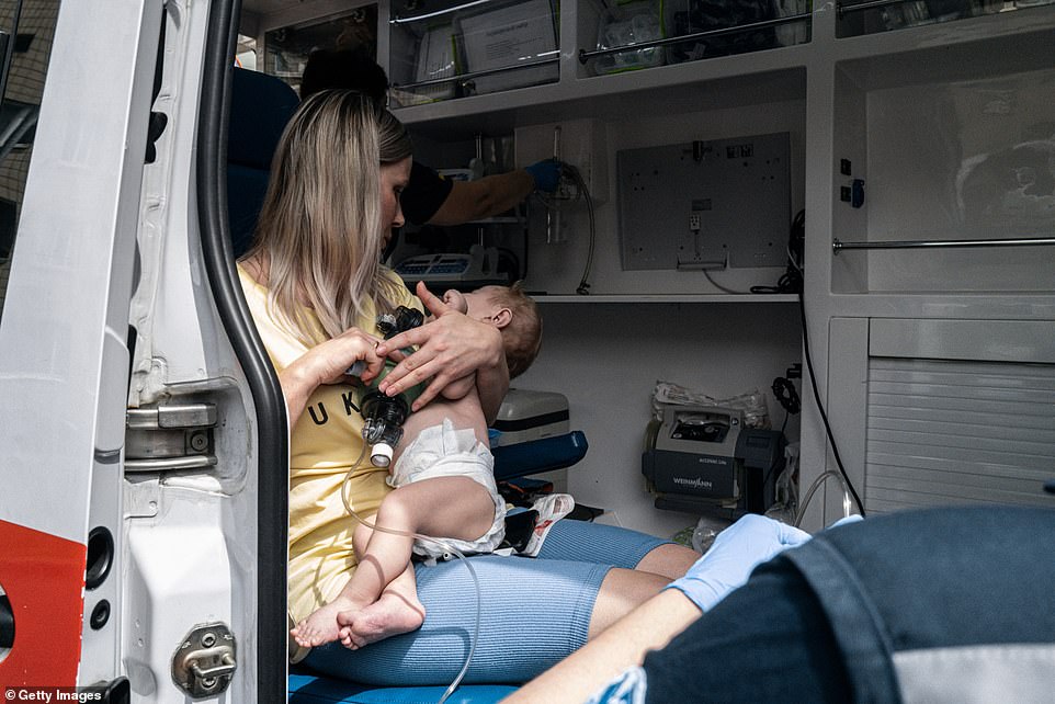 A small child receives medical attention in an ambulance after Monday's missile strikes