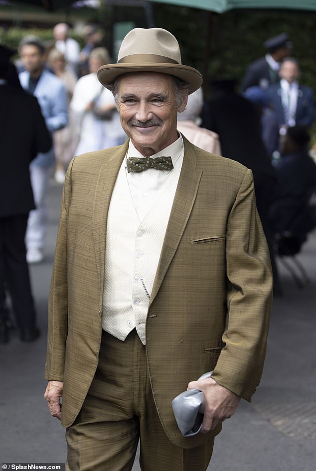 Looking dapper, the star opted for a khaki suit, complete with a white waistcoat and shirt, and a green spotty bow tie