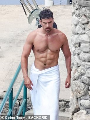 The English actor strolled around the picturesque location with a towel wrapped around his waist