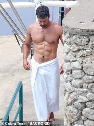 The English actor strolled around the picturesque location with a towel wrapped around his waist