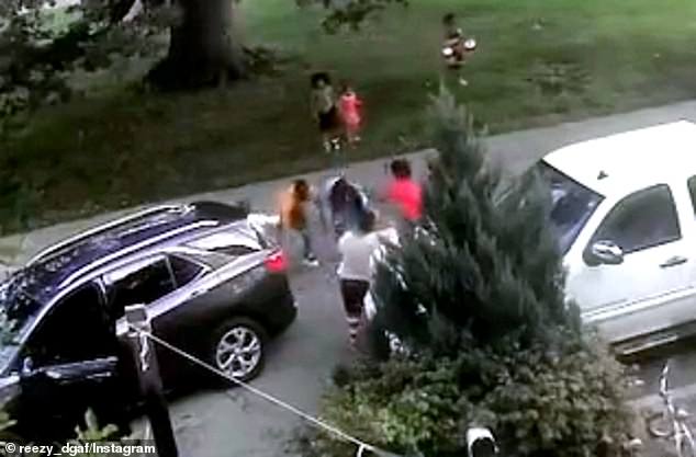 The video then cuts the argument continuing in the middle of the street as the child allegedly fires the gun