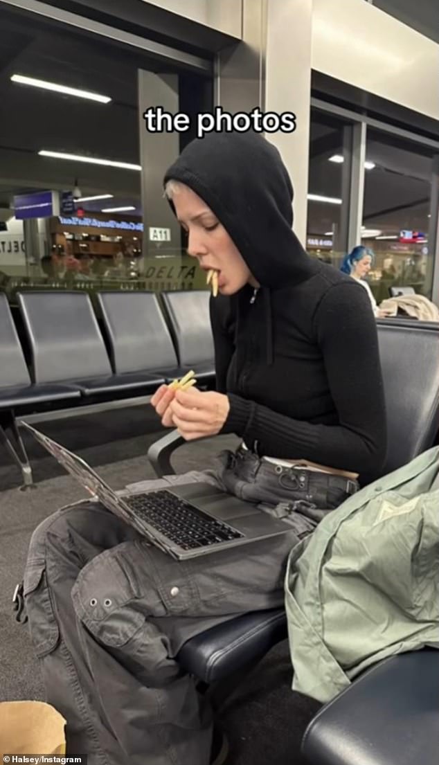 Another image showed her in a black hoodie hunched over her laptop with French fries sticking out of her mouth as she waited at an airport