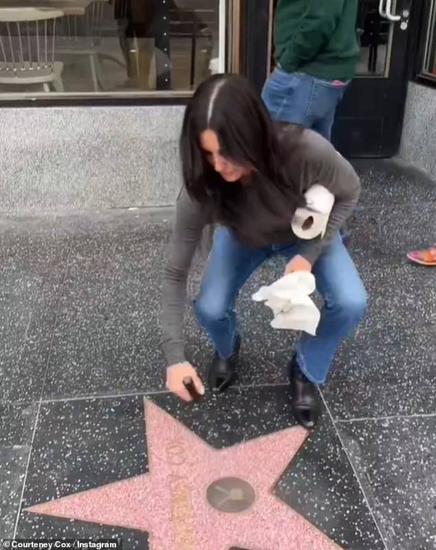 Elsewhere, one video saw her cleaning her own star on the Hollywood walk of fame. 'Someone's gotta do it,' she penned