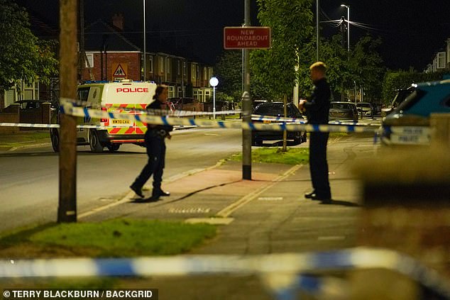 Police officers stand next to a cordon in Geneva Road, Darlington, on Sunday night, July 7, after a 14-year-old girl was found dead at a house on Friday night