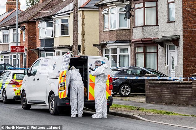 Police in forensics gear stand next to a marked police van outside a property in Geneva Road, Darlington on Sunday, July 7