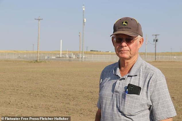 'This would have been a big deal for a lot of farmers,' said Jim Young, a Banner-area wheat farmer whose wind turbine deal was thwarted by new Air Force rules about the missile silos on farms in his area. Above, Young poses in front of a ICBM nuclear silo buried on his farm