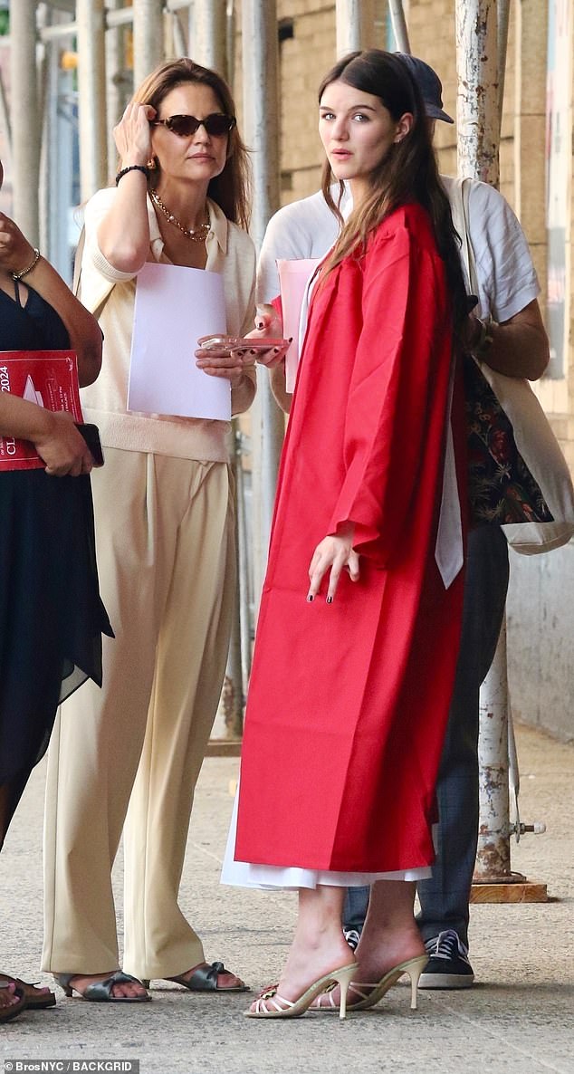 Suri with her mother Katie Holmes at her graduation in Manhattan last month