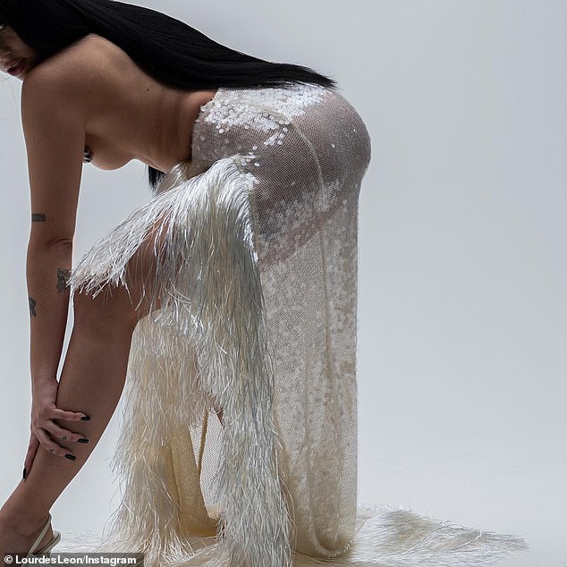 Lourdes posted a faceless image of herself going topless in a white sequined skirt with tassels