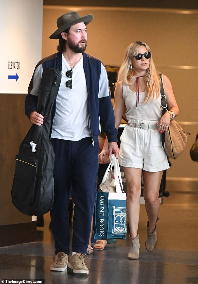 Kate Hudson made a stylish arrival at JFK Airport in New York City with fiancé Danny Fujikawa and their daughter Rani on Tuesday