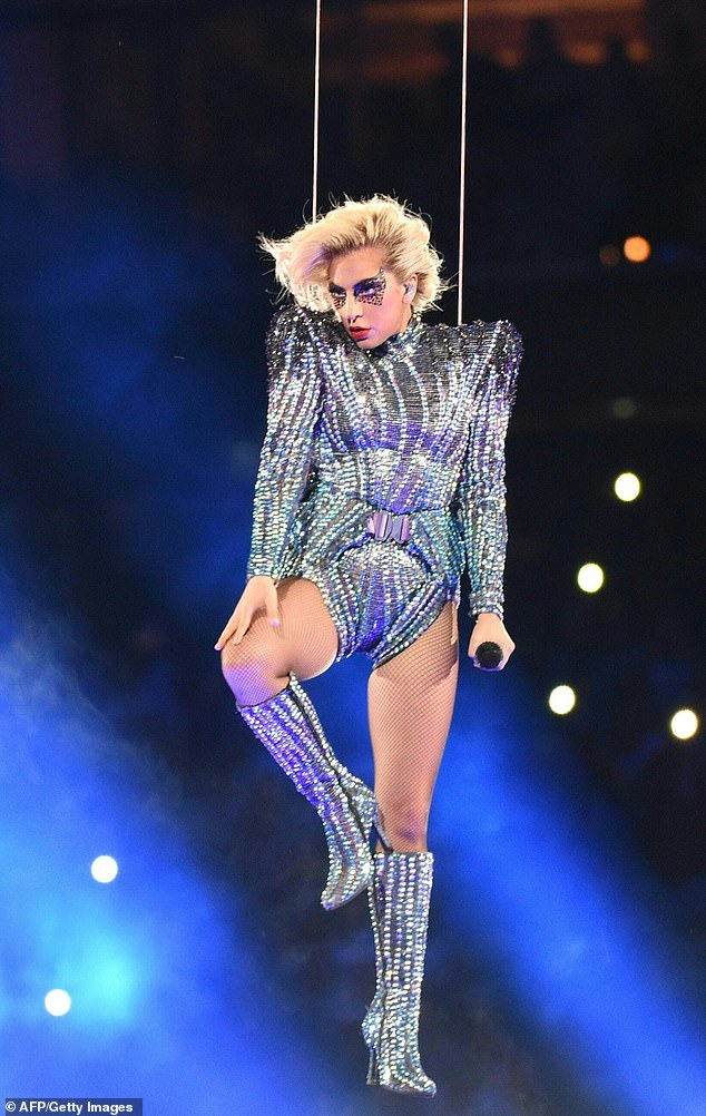 During the Super Bowl LI halftime show in 2017, Lady Gaga made a grand entrance : descending from the stadium roof trapeze-style while singing (stock image)