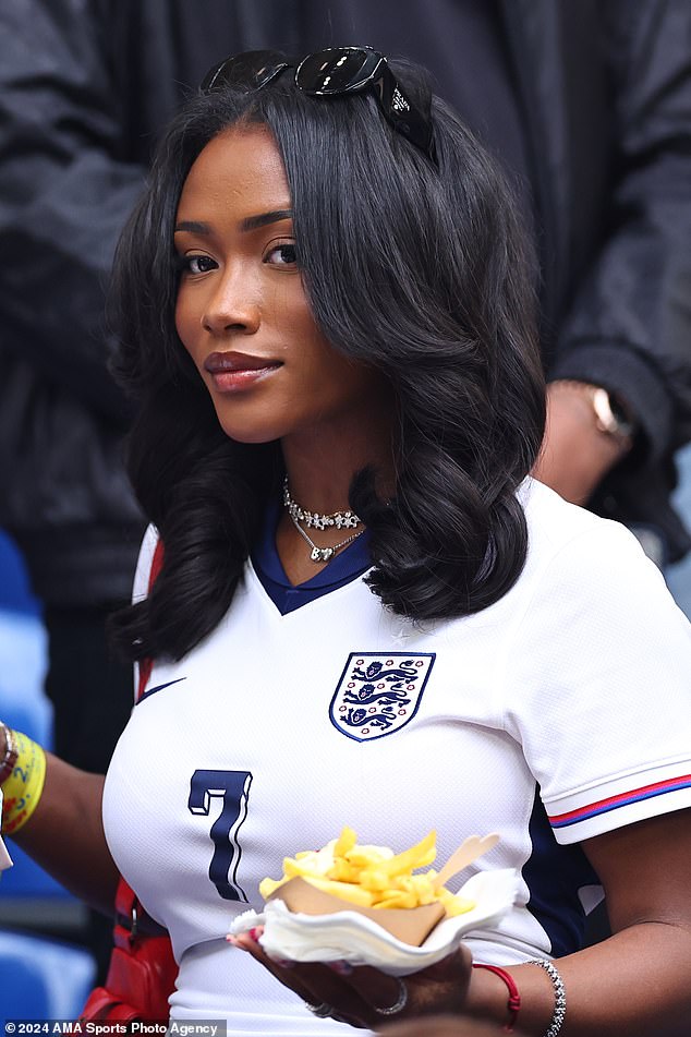 The 23-year-old PR exec has been a down-to-earth presence at England's games, seen here with a tray of chips during the match against Slovakia