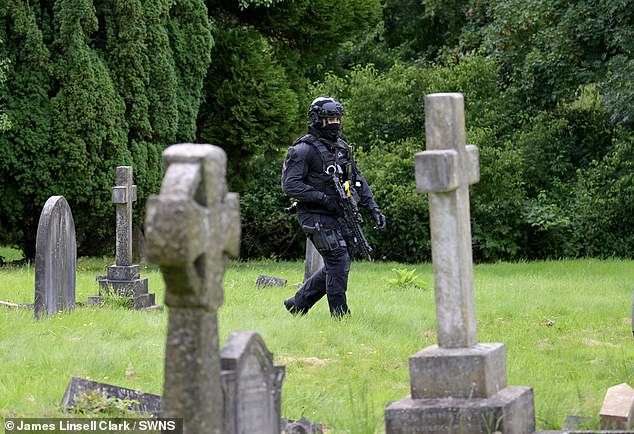 Armed police have been seen carrying out a thorough search of Lavender Hill Cemetery in Enfield