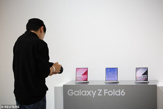 Above, a photographer snaps glamour shots of Samsung's latest Galaxy Z Fold