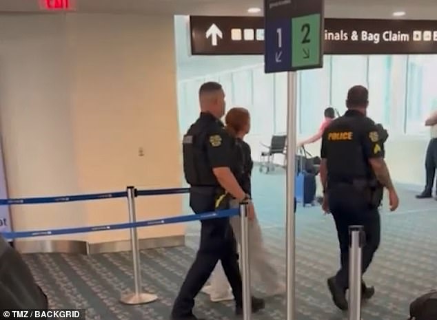 More videos from after the plane landed in Orlando showed the woman being marched out of the airport by police