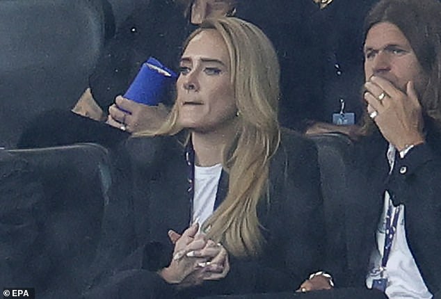 Adele looked tense before kick off as she showed her support to the team. The singer clasped her hands together nervously ahead of kick off as she kept her outfit simple with a black jacket and white T-shirt