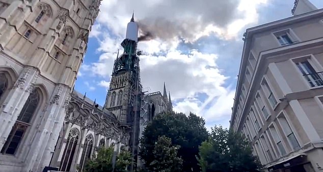 Thick black smoke was filmed pouring out of Rouen Cathedral's main spire in the late morning, in an area where renovation work was taking place