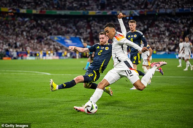 Jamal Musiala (right) caused Anthony Ralston (left) all sorts of trouble in the Euros opener