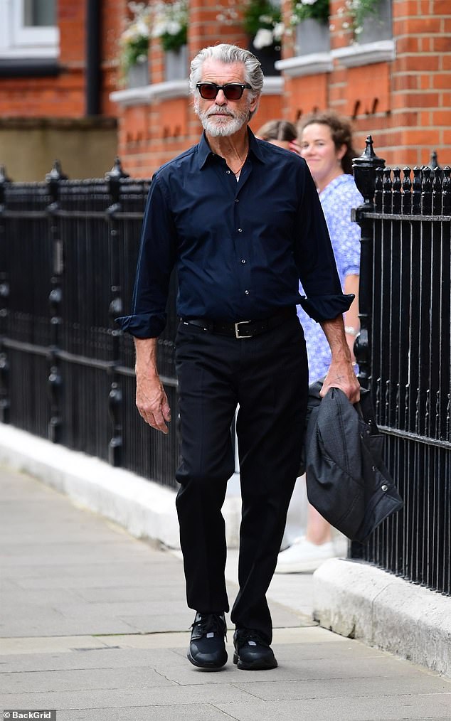 Pierce Brosnan, 71, looked every inch the silver fox as he stepped out dapper as ever in a shirt and sunglasses while he walked around London on Wednesday