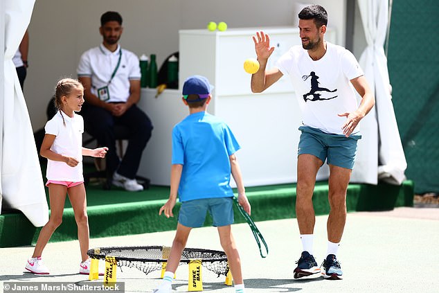 The legendary player enjoyed the sunny day, getting his kids to exercise with him at Wimbledon
