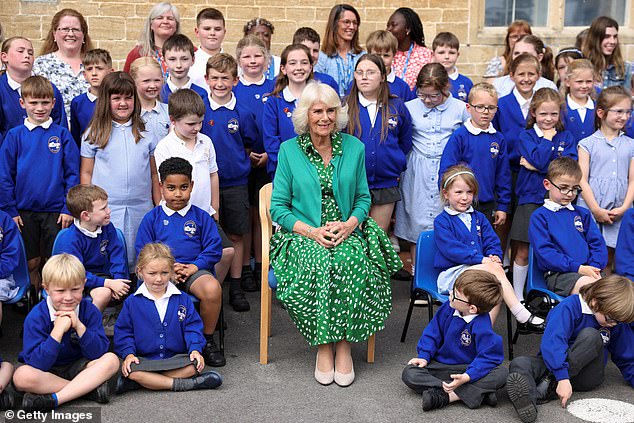 Camilla poses for a picture with students during a visit to Lacock C of E Primary School
