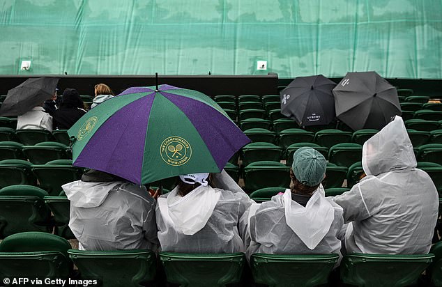 Styling it out in the rain: People are buying umbrellas in droves because they 'want to take some of the magic of Wimbledon home'