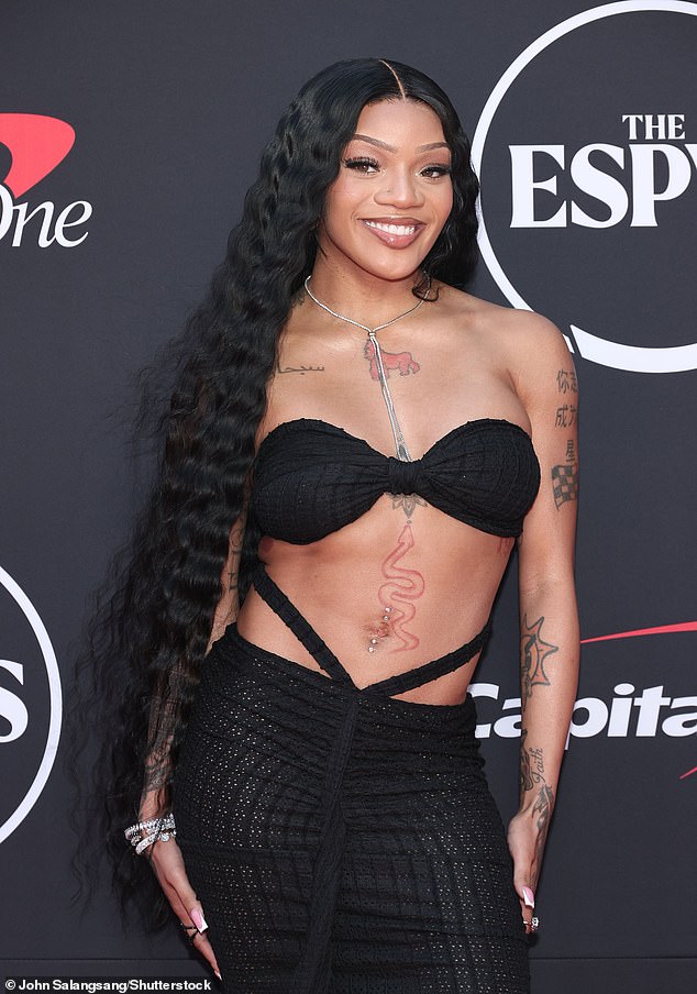 The 24-year-old rapper bared her washboard abs in a slinky, strapless black dress