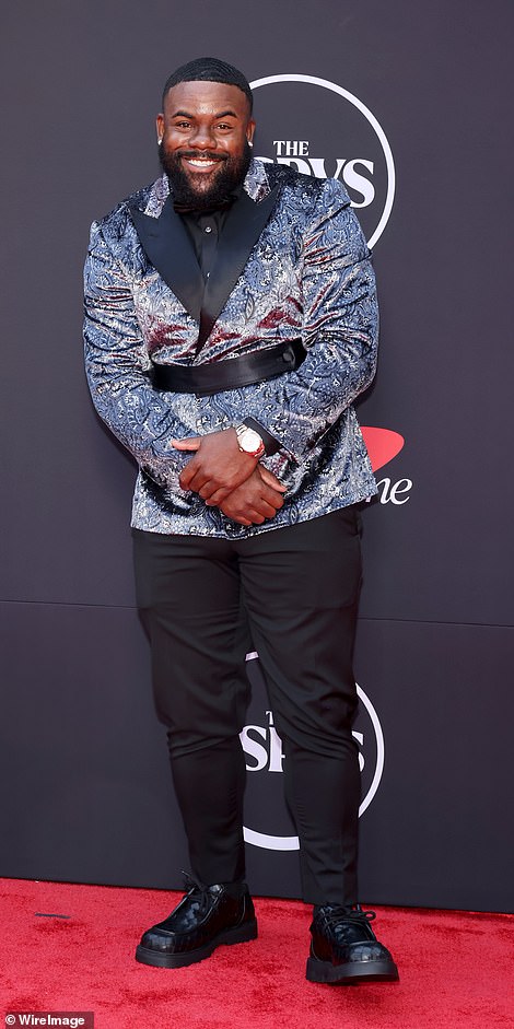 Mark Ingram wore a tux jacket with a blue paisley fabric that was too shiny and didn't properly contrast with his lapels. It was marred by an unnecessary black belt, and he wore too-tight pants