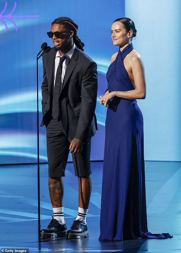 She did take the stage, though, to present an award with Buffalo Bills safety Damar Hamlin during the telecast.