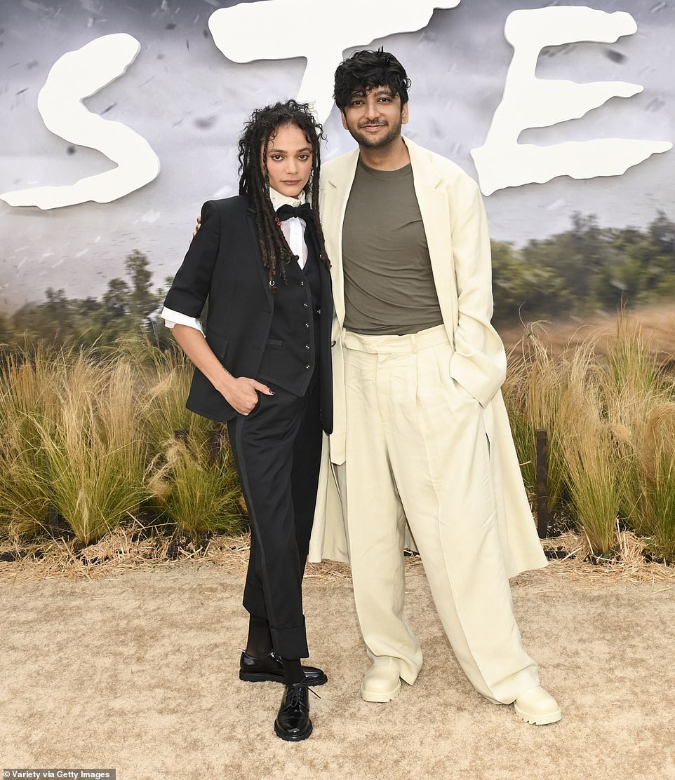 Sasha posed on the red carpet with her costar Nik Dodani, who wore an oversize cream linen suit with baggy pants and a long jacket witth sleeves that completely swallowed up his hands, along with chunky boots in the same shade