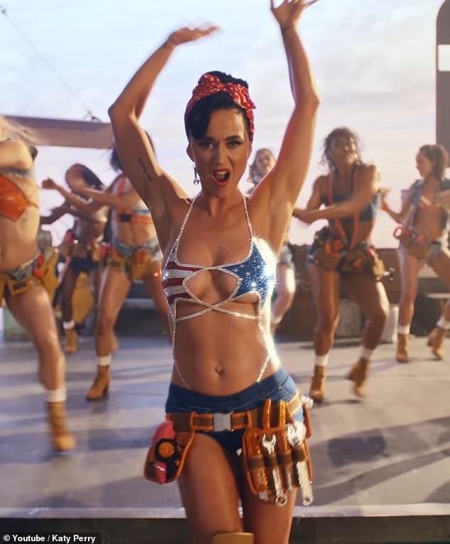 Katy Perry shared the music video for her new single Woman's World on Thursday. In one scene, she has on a tool belt. DailyMail.com has learned it included a pink vibrator