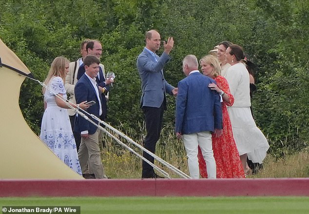 The Prince of Wales speaks to guests outside the US Polo association hospitality tent during the Out-Sourcing Inc Royal Charity Polo Cup