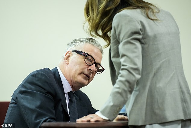Baldwin speaks with his wife Hilaria Baldwin, during his trial on involuntary manslaughter at Santa Fe County District Court in Santa Fe
