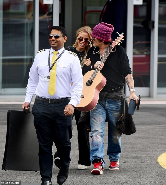 Johnny Depp was seen looking cozy a Russian beautician named Yulia  Thursday while traveling out of London Heliport with his entourage