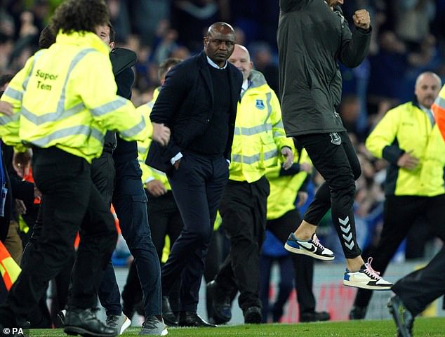 Arsenal legend Patrick Vieira (center) kicked out at an Everton fan as Crystal Palace manager